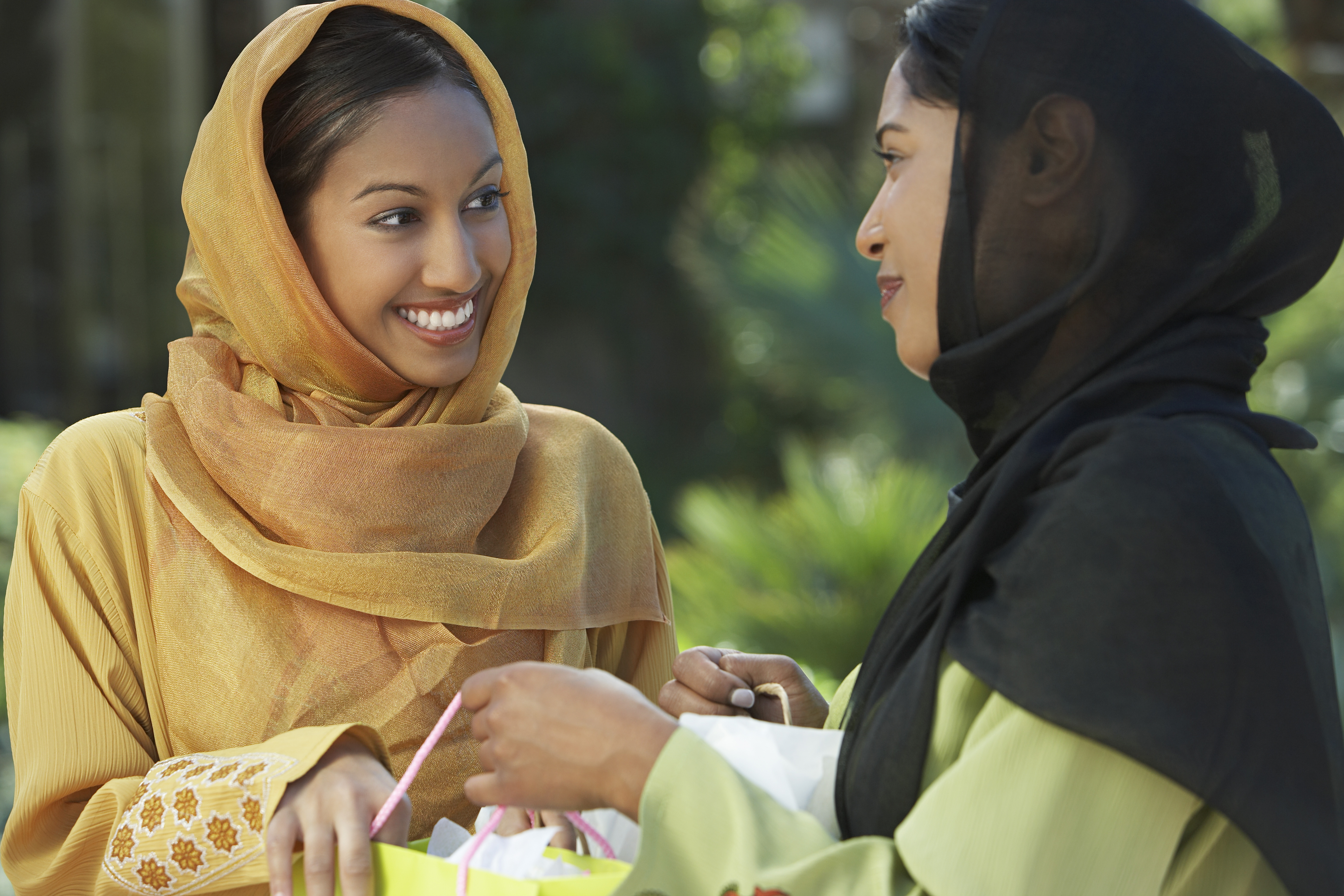 Two young muslim women talking outdoors